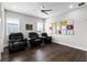 Cozy living room with ceiling fan and dark hardwood flooring offers a comfortable retreat at 16028 Trivoli Cir, Montverde, FL 34756