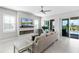 Spacious living room with a fireplace, ceiling fan, and access to the outdoor patio and pool area at 16028 Trivoli Cir, Montverde, FL 34756