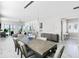 Open-concept living room with dining area, modern lighting, and sliding glass doors to outdoor space at 16028 Trivoli Cir, Montverde, FL 34756
