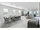 Spacious living area featuring sleek tile floors, modern lighting, fireplace, and large windows at 16028 Trivoli Cir, Montverde, FL 34756