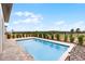 A backyard pool with a brick surround and a view of a distant landscape at 16028 Trivoli Cir, Montverde, FL 34756