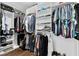 Bright walk-in closet with custom shelving and hanging racks offer optimal organization and style at 16028 Trivoli Cir, Montverde, FL 34756
