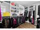 Bright walk-in closet with custom shelving, hanging racks and wood floor offer optimal organization and style at 16028 Trivoli Cir, Montverde, FL 34756