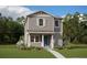 Charming two-story home featuring gray siding, a welcoming front porch, and a beautifully landscaped front yard at 16854 Hamlin Vista Aly, Winter Garden, FL 34787
