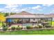 Enjoy the outdoors in this home's backyard, complete with a screened-in pool, patio area, and well-manicured landscaping at 17066 Se 111Th Ter, Summerfield, FL 34491