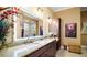 A bathroom with granite countertops and dual sinks at 17066 Se 111Th Ter, Summerfield, FL 34491