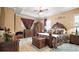 This primary bedroom features tray ceilings, a ceiling fan, and wood flooring at 17066 Se 111Th Ter, Summerfield, FL 34491