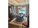 Formal dining room offers a tray ceiling, chandelier, hutch, and large windows at 17066 Se 111Th Ter, Summerfield, FL 34491
