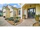 Inviting entrance with brick walkway, manicured landscaping, columns, and detailed front door at 17066 Se 111Th Ter, Summerfield, FL 34491