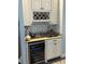 A kitchen with a wine cooler, wine rack, sink, and a granite countertop at 17066 Se 111Th Ter, Summerfield, FL 34491