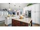 Spacious kitchen featuring white cabinets, large center island, granite countertops, and stainless steel appliances at 17066 Se 111Th Ter, Summerfield, FL 34491