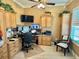 Home office with built-in cabinets, desk and multiple monitors at 17066 Se 111Th Ter, Summerfield, FL 34491