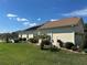 Charming home exterior boasts a well-manicured lawn, lush landscaping, and a private screened-in lanai for outdoor enjoyment at 17066 Se 111Th Ter, Summerfield, FL 34491