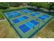 Overhead view of well-maintained tennis and pickleball courts surrounded by lush greenery, perfect for active recreation at 17066 Se 111Th Ter, Summerfield, FL 34491