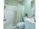 Bathroom showcasing a walk-in shower, a toilet, white vanity, and fresh green paint at 1723 Morelos Rd, The Villages, FL 32159