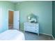 Bright bedroom featuring a decorative dresser, adjacent to an open doorway showcasing the house's layout at 1723 Morelos Rd, The Villages, FL 32159