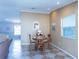 Cozy dining area features a table set for four, with elegant decor and a view into the living area at 1723 Morelos Rd, The Villages, FL 32159