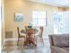 Inviting dining area with a round table set for four, complemented by neutral tones and natural light at 1723 Morelos Rd, The Villages, FL 32159