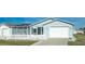 Delightful blue home with a garage and a welcoming white picket fence, offering a cozy and inviting atmosphere at 1723 Morelos Rd, The Villages, FL 32159