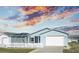 Charming home with a white picket fence and manicured lawn under a captivating sunset sky at 1723 Morelos Rd, The Villages, FL 32159