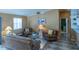 Comfortable living room furnished with plush seating, a ceiling fan, and bright lamps for a warm ambiance at 1723 Morelos Rd, The Villages, FL 32159