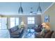 Bright and airy living room with stylish seating, a ceiling fan, and sliding glass doors to a patio at 1723 Morelos Rd, The Villages, FL 32159