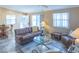 Well-lit living room featuring comfortable seating, a glass coffee table, and stylish accents for relaxation at 1723 Morelos Rd, The Villages, FL 32159