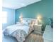 Comfortable main bedroom features soft lighting, calming colors, and carpeted floors at 1723 Morelos Rd, The Villages, FL 32159