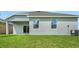 The backyard showcases well-maintained lawn, windows, and outdoor AC unit at 179 Bottle Brush Dr, Haines City, FL 33844