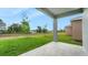 The home has a covered porch with beautiful backyard and lush green grass at 179 Bottle Brush Dr, Haines City, FL 33844