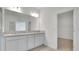 Bright bathroom with double vanity and walk-in closet access at 179 Bottle Brush Dr, Haines City, FL 33844