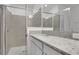 Bathroom featuring granite counters, framed mirrors, and a glass enclosed shower at 179 Bottle Brush Dr, Haines City, FL 33844