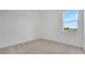 Bedroom featuring neutral carpet, white walls and trim, and a bright window at 179 Bottle Brush Dr, Haines City, FL 33844