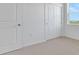 Bedroom with neutral carpet, white walls, and doors at 179 Bottle Brush Dr, Haines City, FL 33844