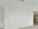 Empty bedroom featuring neutral paint and carpet, as well as standard trim and an interior door at 179 Bottle Brush Dr, Haines City, FL 33844