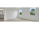Empty bedroom featuring neutral paint and carpet, as well as two large windows providing natural light at 179 Bottle Brush Dr, Haines City, FL 33844