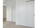 Bedroom view showcasing a closet with sliding doors and a separate door leading to another room at 179 Bottle Brush Dr, Haines City, FL 33844