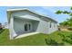 Exterior view of the home highlighting the covered patio and spacious backyard at 179 Bottle Brush Dr, Haines City, FL 33844