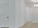 Open hallway showcasing neutral walls and floors with doorways to multiple rooms at 179 Bottle Brush Dr, Haines City, FL 33844