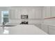 Bright kitchen featuring white cabinets, stainless appliances, and sleek countertops at 179 Bottle Brush Dr, Haines City, FL 33844