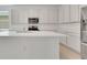 Modern kitchen featuring white countertops, stainless steel appliances, and ample cabinet space at 179 Bottle Brush Dr, Haines City, FL 33844