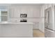 Modern kitchen featuring stainless steel appliances, island with white counters, and shaker cabinets at 179 Bottle Brush Dr, Haines City, FL 33844