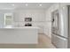 Stylish kitchen featuring sleek stainless steel appliances and bright white cabinets and countertops at 179 Bottle Brush Dr, Haines City, FL 33844