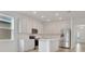Bright kitchen boasts stainless steel appliances, white cabinets, and an island at 179 Bottle Brush Dr, Haines City, FL 33844