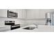 This kitchen features white cabinetry, stainless steel appliances, and a stylish countertop at 179 Bottle Brush Dr, Haines City, FL 33844