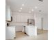 Spacious kitchen with white cabinetry, stainless steel appliances and an island at 179 Bottle Brush Dr, Haines City, FL 33844