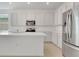 Modern kitchen featuring stainless steel appliances, an island, and white shaker-style cabinetry at 179 Bottle Brush Dr, Haines City, FL 33844
