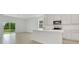 Open-concept kitchen with modern white cabinets, stainless steel appliances, and a view to backyard at 179 Bottle Brush Dr, Haines City, FL 33844