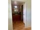 Bathroom featuring a wood vanity with a mirror above and a white door on the right at 201 Jacaranda Dr, Leesburg, FL 34748