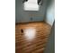 Cozy bedroom features wood floors and a bright window at 201 Jacaranda Dr, Leesburg, FL 34748